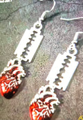 Dangle earrings with red beating hearts and razor blades